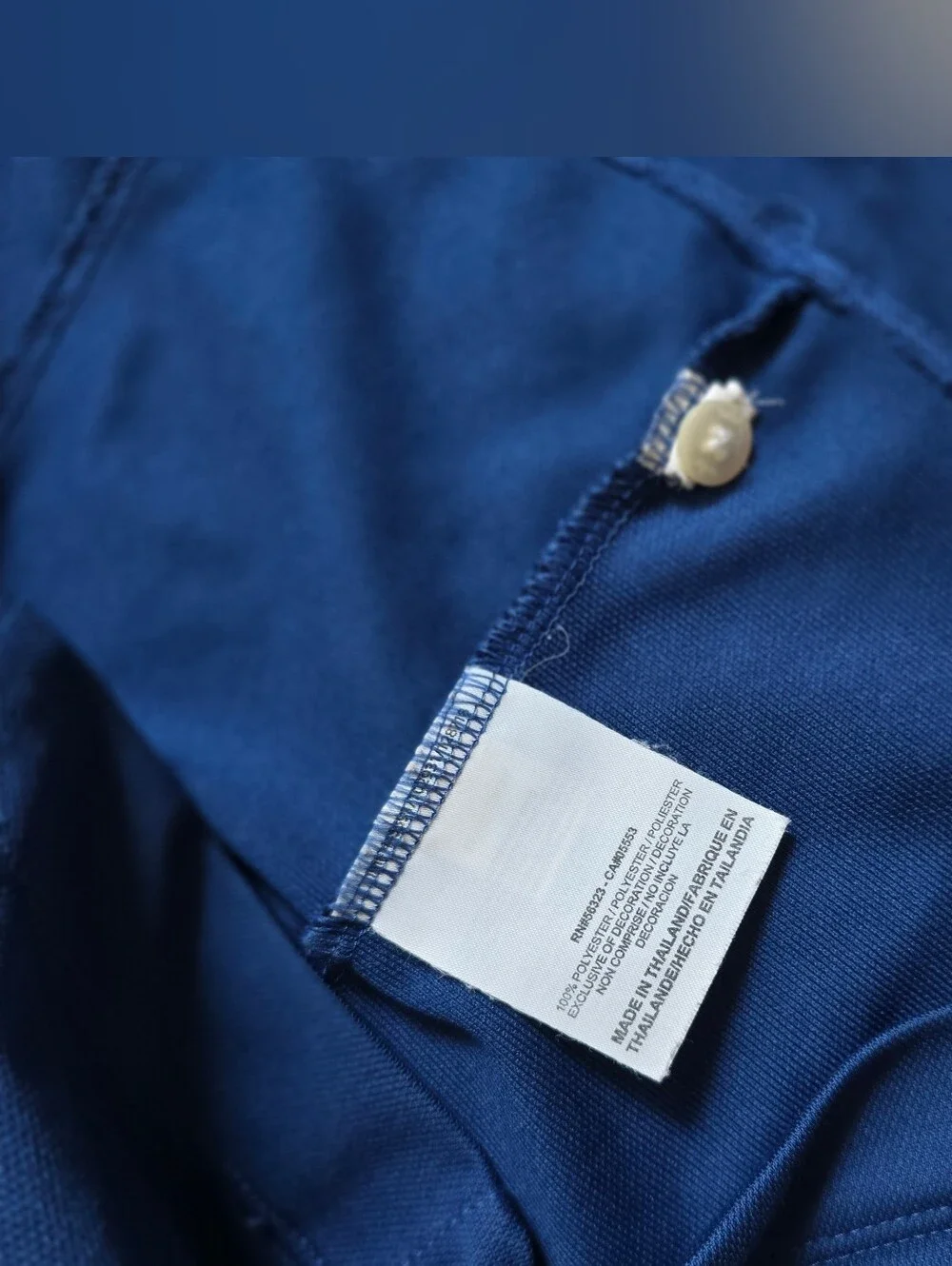 Royal blue sleeveless Nike Golf polo featuring a white-buttone